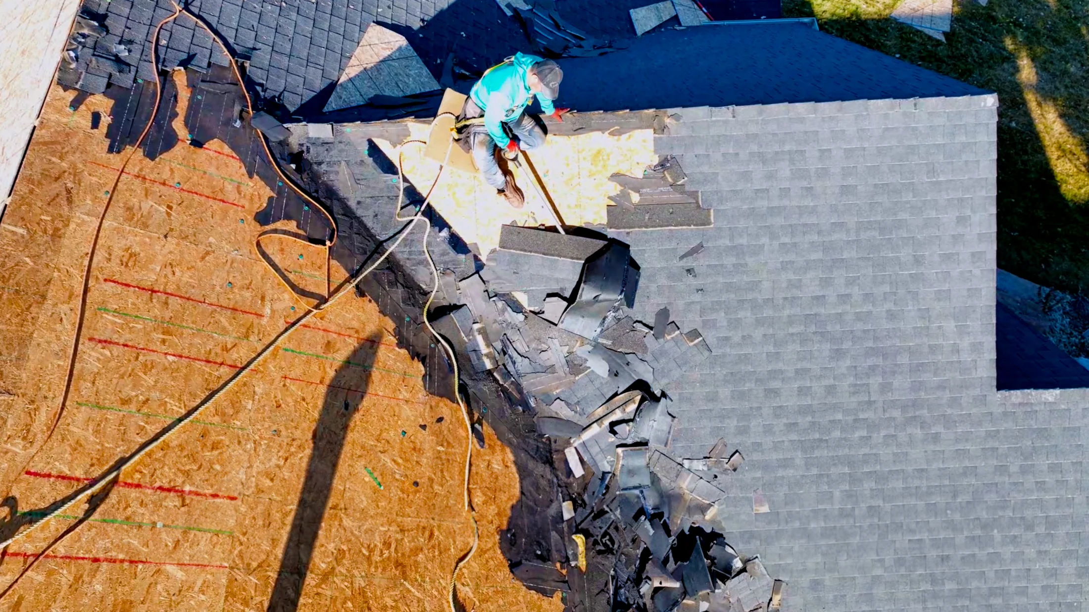 Exposed roof decking and shingles during a residential roof replacement